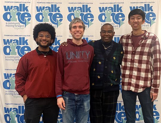 In League with STEM team members honored by Champaign Country Community Coalition. From left to right: Julian Martinez, Caleb Bruhn, Pastor Willie Comer, and Kendall Koe